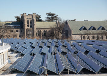 Solar Panels on the roof of 38 Oxford street are framed by Andover Hall at the The Harvard Divinity School. Seen from the Northwest Building.