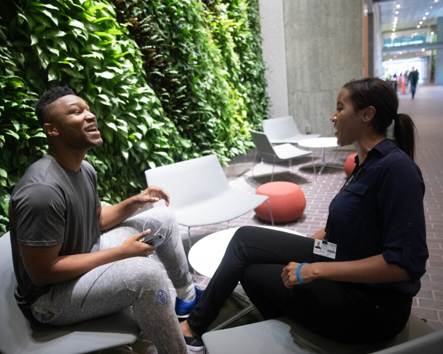 Former Harvard men's basketball player, Zena Edosomwan '17 and Tiana Woolridge, PhD candidate, enjoy one of many green walls in the The new Richard A. Susan F. Smith Campus Center