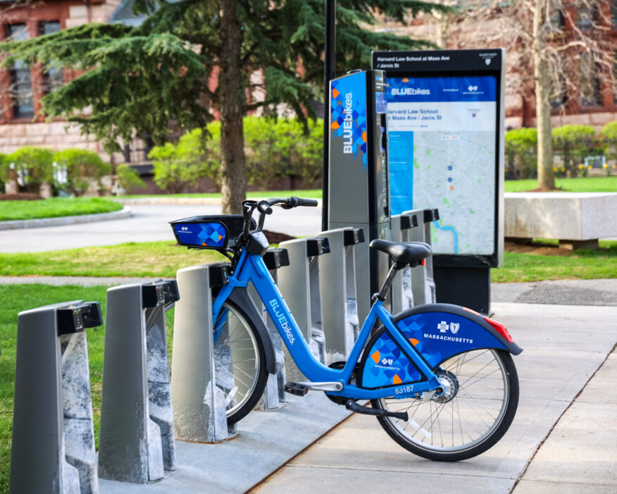 A BlueBikes station at Harvard Law School on a sunny day has only one bike docked.