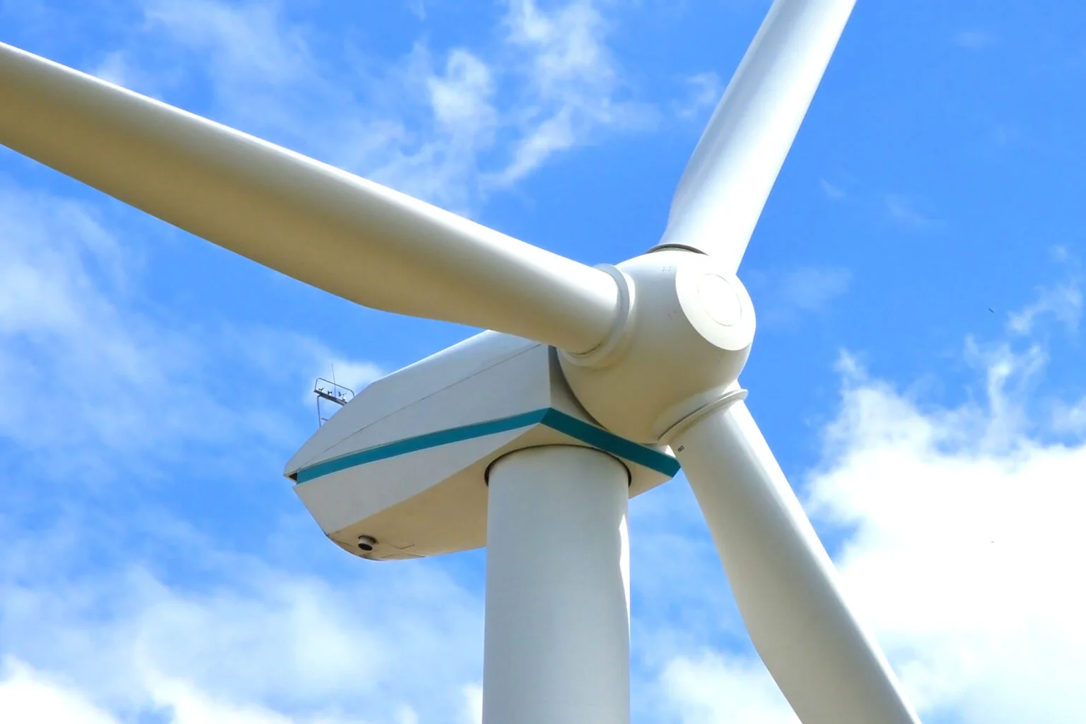 Wind turbine against a blue sky.