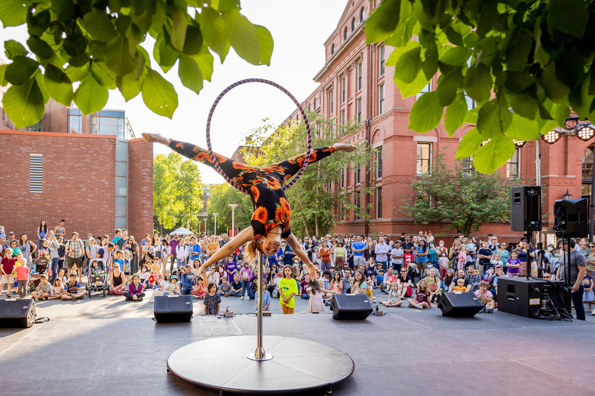 Photo of an acrobat performing in front of a crowd at Harvard.
