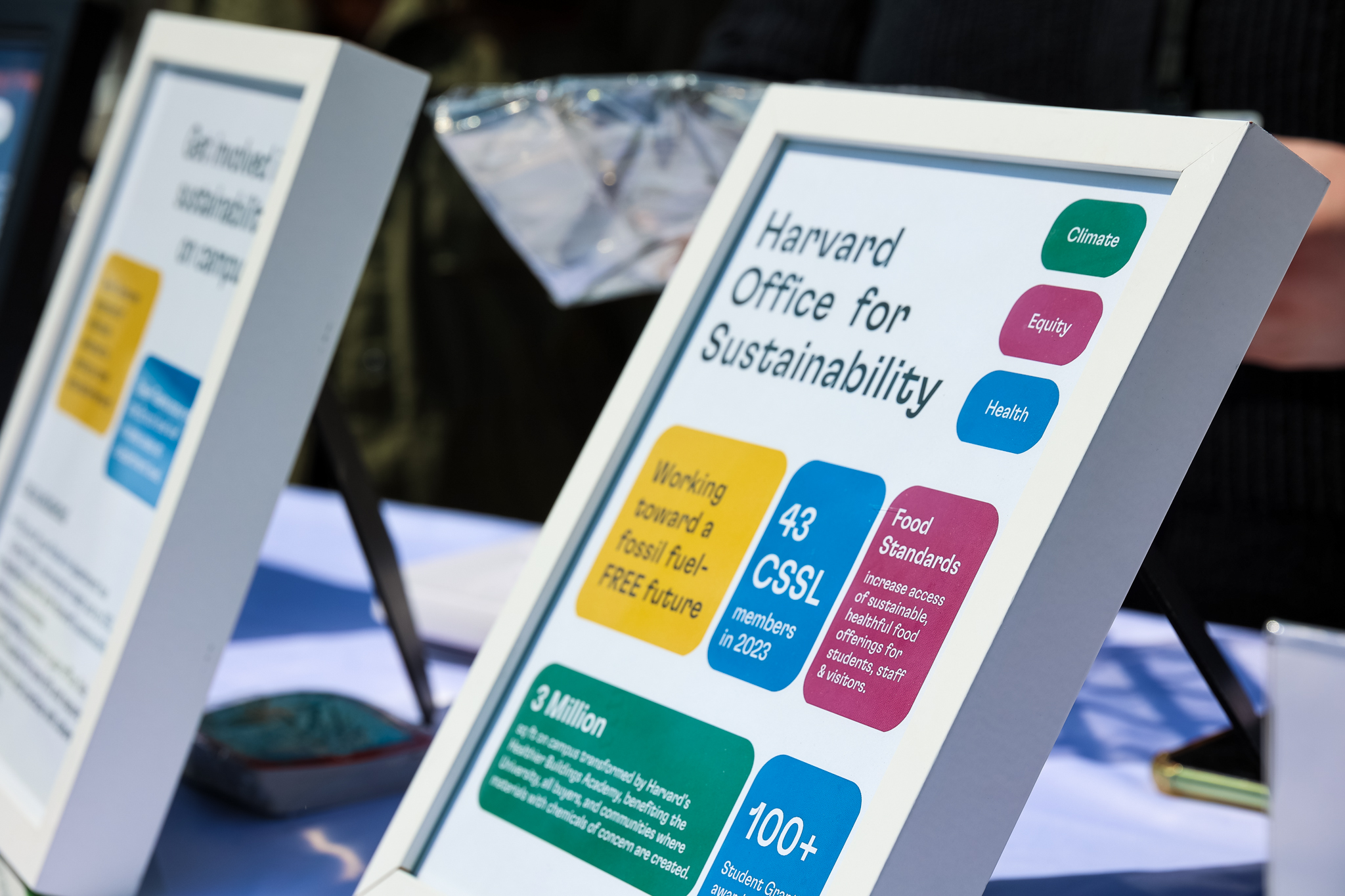 Close-up of tabling materials and signage during a Harvard Earth Day event in 2023.